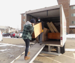 AmeriCorps members unload the Houses Into Homes truck during one of the deliveries during their service day.
